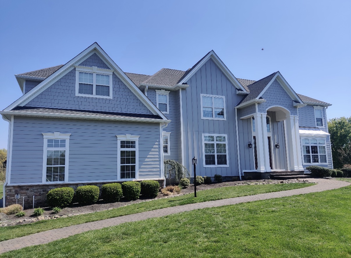 Light blue Hardie siding home with white trim