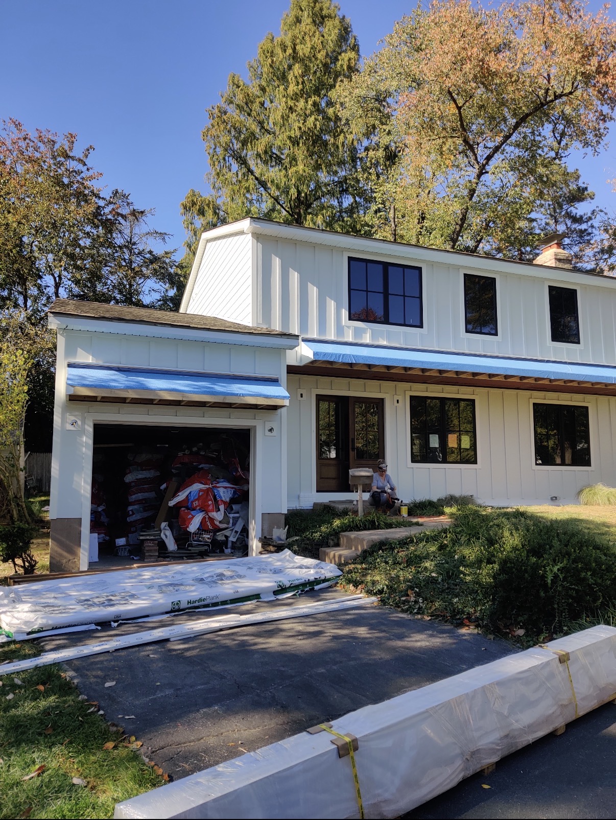 White board-and-batten Hardie installation in progress