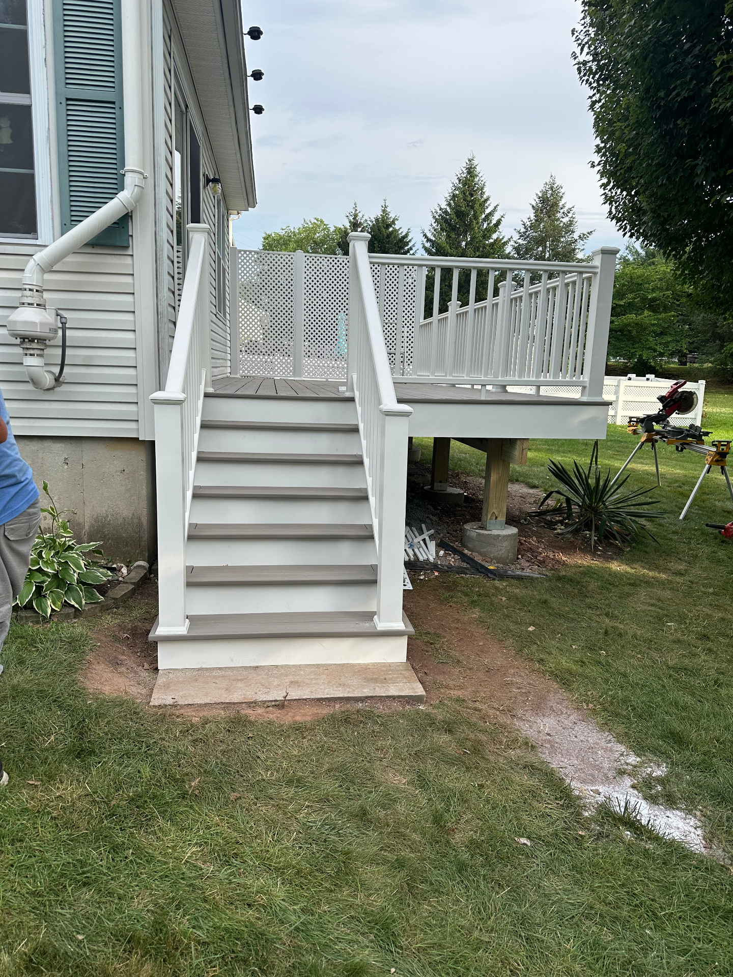 New composite deck stairs with white vinyl railings and lattice privacy screen